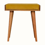 Small square tray-style bench in a yellow velvet, and a natural wooden body.