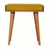 Small square tray-style bench in a yellow velvet, and a natural wooden body.