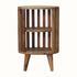 A natural finish mango wood bedside table with a slatted design and two open shelves.