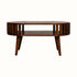 A chestnut stained wooden coffee table, featuring an open slot shelf, and slatted design.