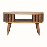 A natural stained mango wood coffee table, featuring open shelving, and slatted design. 