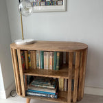 Solid wood open bookcase in a light brown stain.