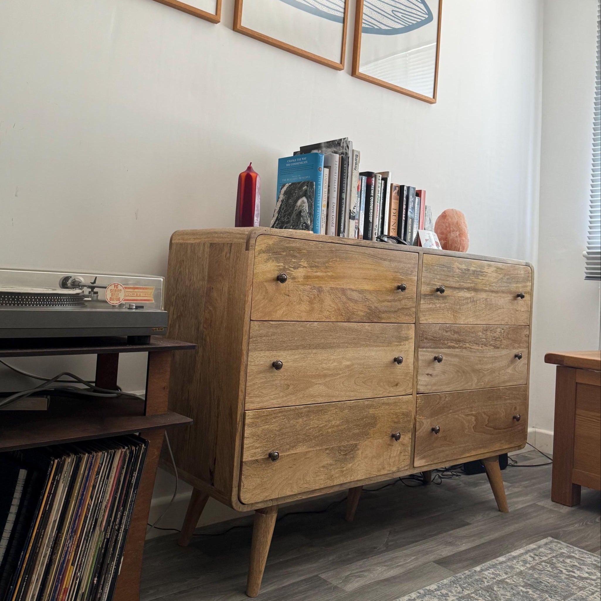 Decorated room featuring a large chest of 6 drawers made from mango wood in a light brown finish.