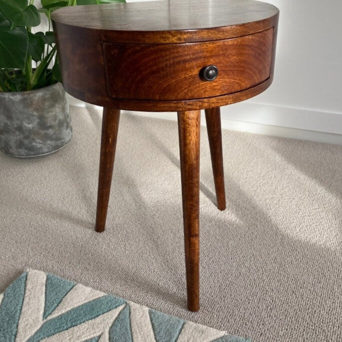 A vintage style bedside table made from solid wood, in a dark brown chestnut finish, featuring a semi-circular shape body.