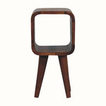 A mini-sized brown bedside table with open shelving and a circular slot compartment, handcrafted from sustainably sourced mango wood.