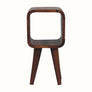 A mini-sized brown bedside table with open shelving and a circular slot compartment, handcrafted from sustainably sourced mango wood.
