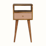 Scandinavian style bedside table made from solid wood in light brown finish, with handpainted pink drawer front.