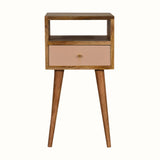 Scandinavian style bedside table made from solid wood in light brown finish, with handpainted pink drawer front.