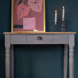 Wooden desk styled as a console in a french grey paint.