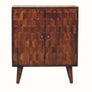 A small Marina Cabinet with hand-carved pineapple pattern in chestnut color, featuring two doors with brass knobs and four short legs.