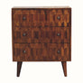 A small chest of drawers with a chestnut brown finish, featuring a geometric pattern on the drawer fronts and supported by four short tapered legs.
