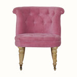 Vintage style seat in pink velvet, with light wood legs.
