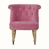 Vintage style seat in pink velvet, with light wood legs.