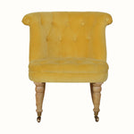 Vintage style seat upholstered in yellow velvet, with light wood legs.