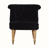 Vintage style seat in black velvet, with light wood legs.
