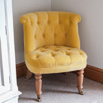 Antique style seat in yellow velvet, with light mango wood legs.