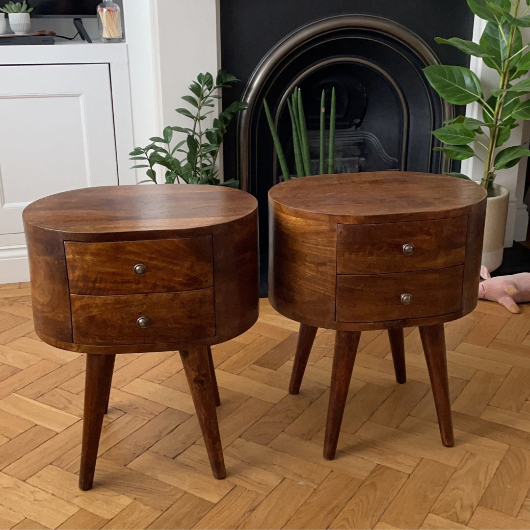 Two bedside tables made from solid wood in a dark brown stain inside a stylish living room.