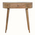 A round, natural wood console table with a drawer and tapered legs.