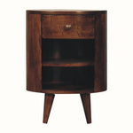 A bedside table with one drawer and two open shelves, handmade from mango wood in a dark brown, california walnut finish.