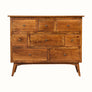 A chest of eight drawers made of mango wood with brass knobs, featuring a traditional Norwegian design with a flat tabletop.