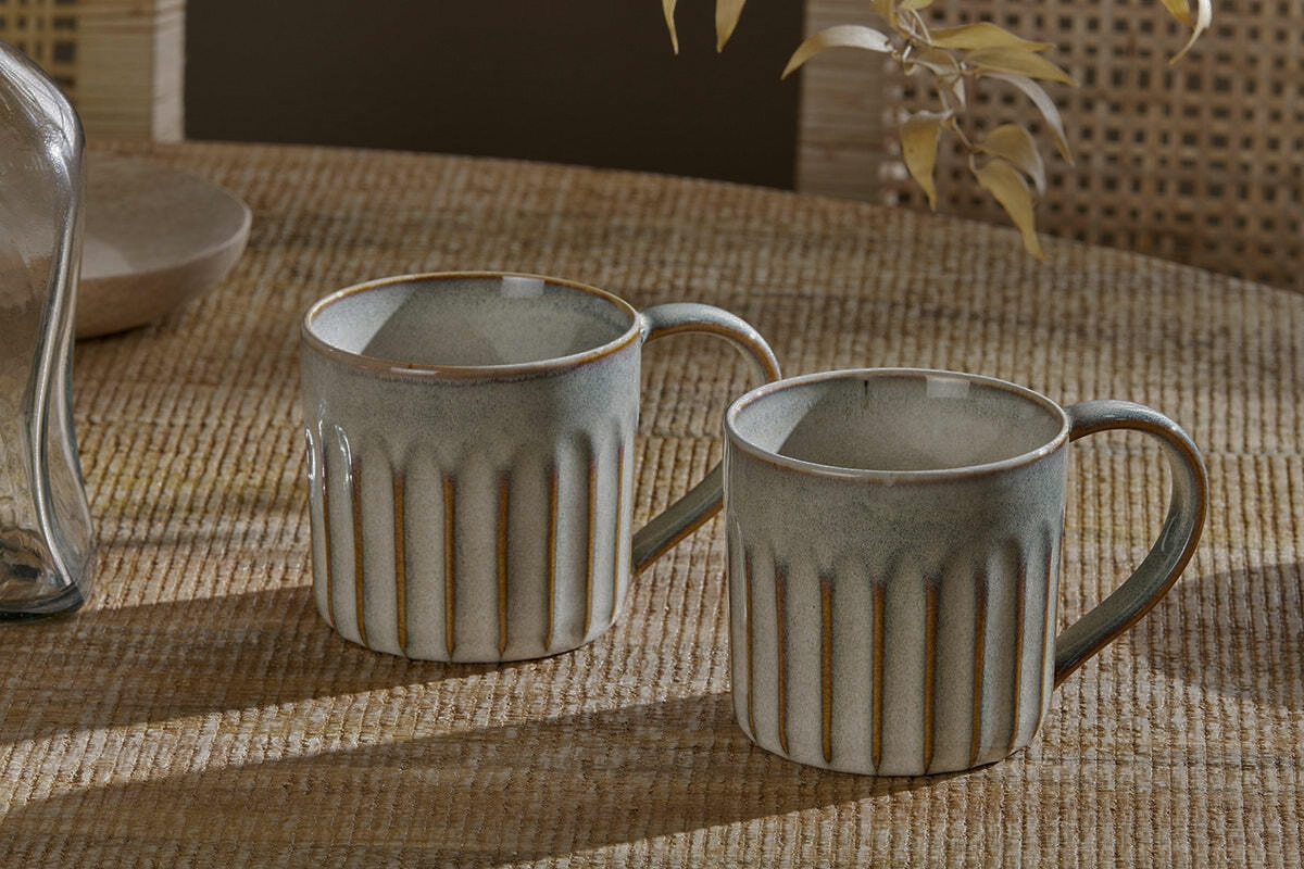 Two stoneware glazed mugs.