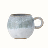 A small round mug with a handle in a blue reactive glaze.