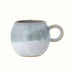A small round mug with a handle in a blue reactive glaze.