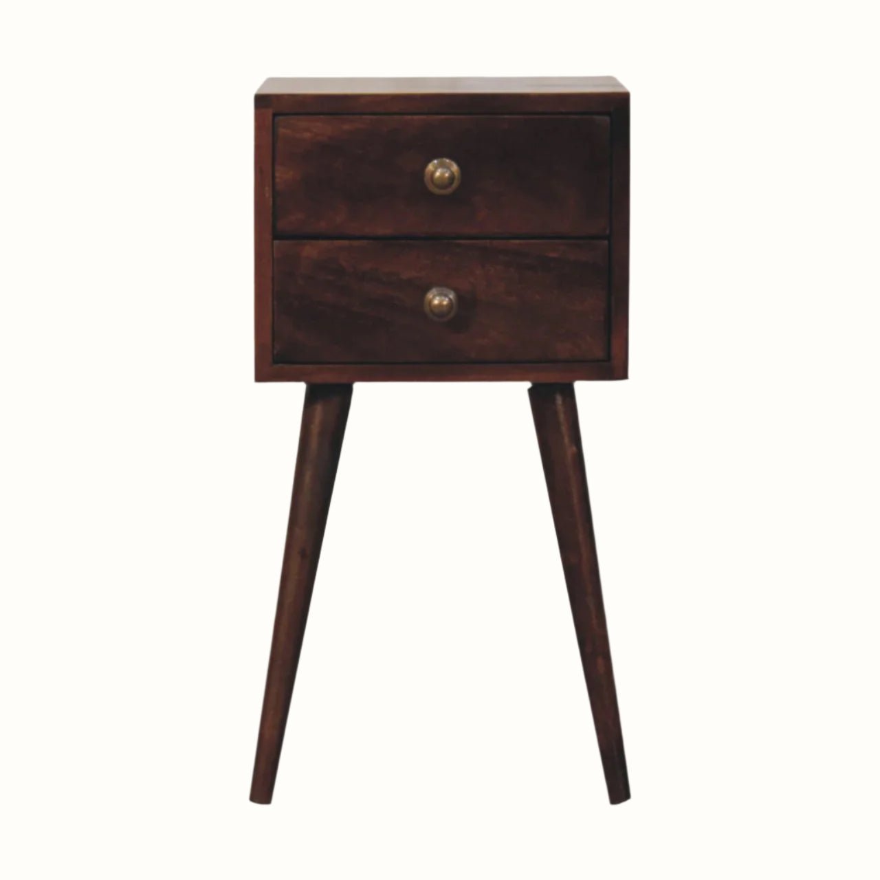 A small bedside table made of mango wood with two drawers, brass knobs, and tapered legs.