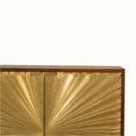 Gold leaf cabinet with a decorative pattern on a white background