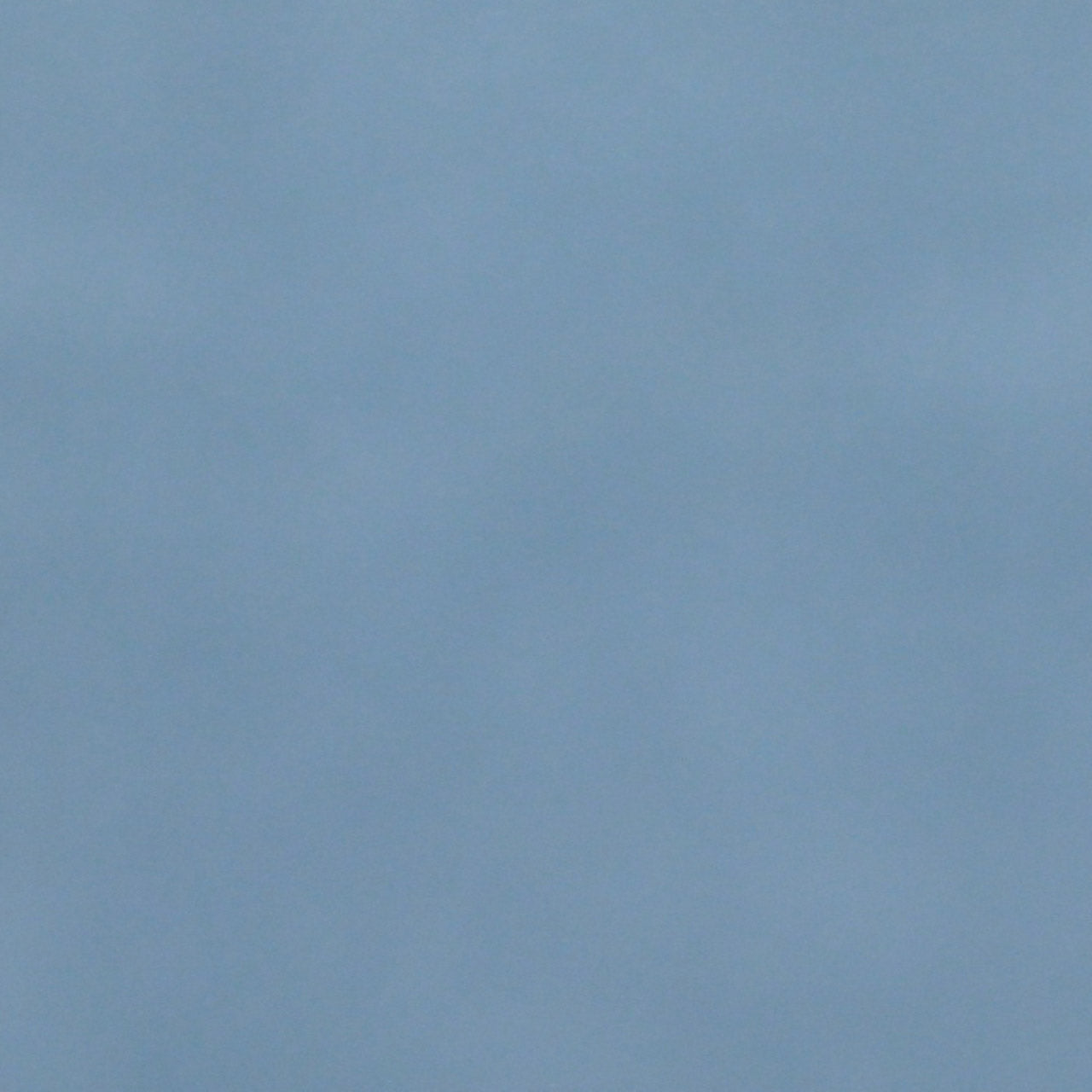 A close up photograph showing our vintage blue paint sample.