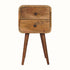 A small natural wood bedside table with two drawers and four Nordic-style legs.