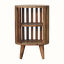 A natural finish mango wood bedside table with a slatted design and two open shelves.