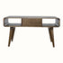 A grey wash Hamade open coffee table made of solid mango wood, featuring two open slot shelves, two drawers, and four tapered legs with brass knob hardware.