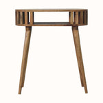A natural finish mango wood console table with a slatted design and open slot shelf.