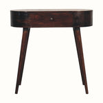 A curved console table with a light walnut finish, featuring a drawer with a brass knob and tapered legs.