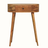 A curved-shaped, natural finish console table with a drawer and tapered legs, made from solid mango wood.