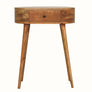 A curved-shaped, natural finish console table with a drawer and tapered legs, made from solid mango wood.