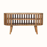 A medium-sized round TV Stand made of natural finish mango wood, featuring a slatted design and two open shelves.