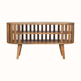 A medium-sized round TV Stand made of natural finish mango wood, featuring a slatted design and two open shelves.